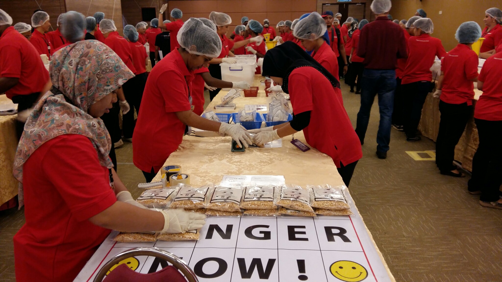 Stop Hunger Now fortified rice being packed by Sunway workers and staff