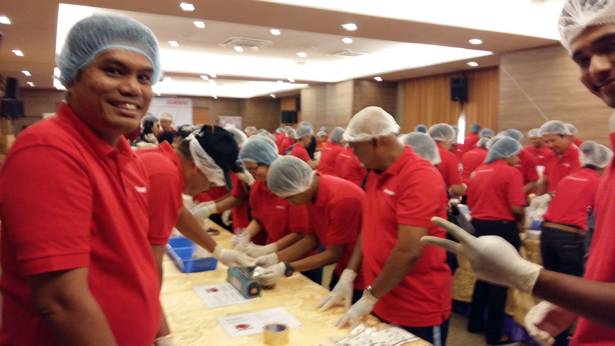 Stop Hunger Now fortified rice being packed by Sunway workers and staff