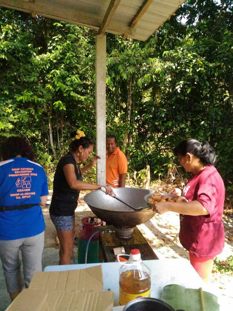 SSVP members cooking up a feast for lunch