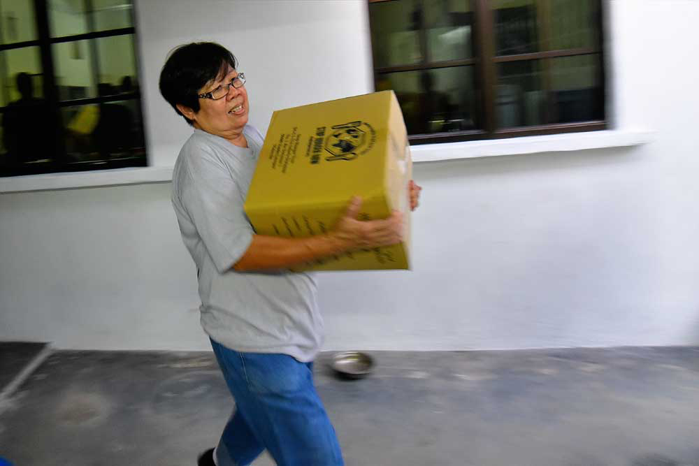 Auntie Nancy helping to store fortified rice