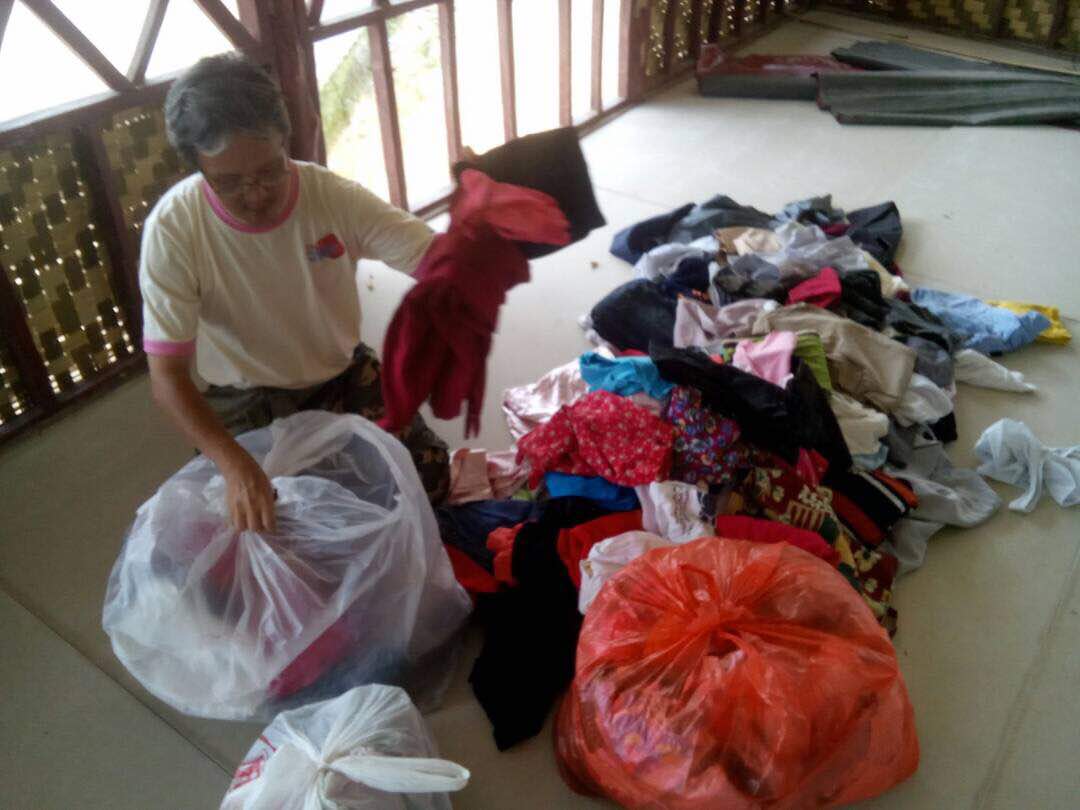 Sorting donated clothes for OA village