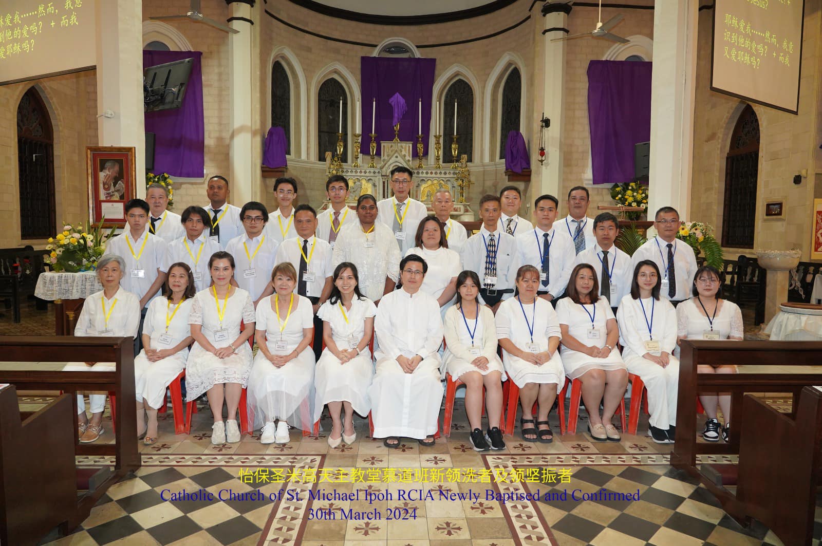 The newly baptised with Fr Anthony Liew on the night of Easter Vigil 2024